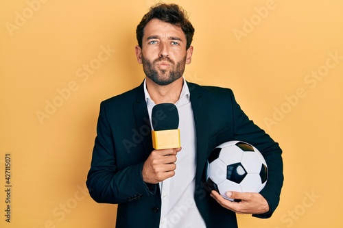 Handsome man with beard football reporter microphone looking at the camera blowing a kiss being lovely and sexy. love expression.