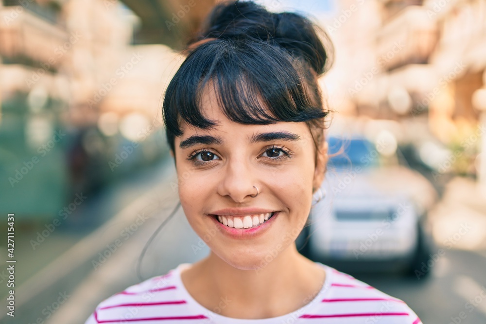 Young hispanic girl smiling happy walking at the city.