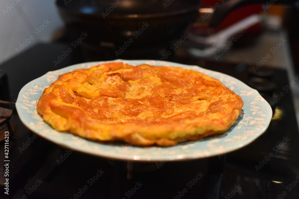 Closeup of a plate with a typical omelet. Picture have noise, Soft focus. Closeup of a plate with a typical omelet. Picture have noise, Soft focus.