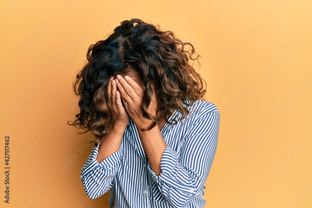 Middle age hispanic woman wearing casual clothes with sad expression covering face with hands while crying. depression concept. Middle age hispanic woman wearing casual clothes with sad expression covering face with hands while crying. depression concept.