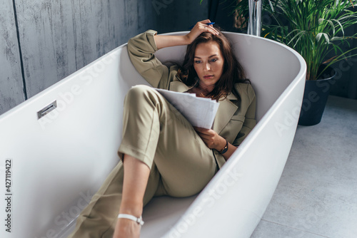 Woman locked herself in the bathroom to work with documents. Work from home