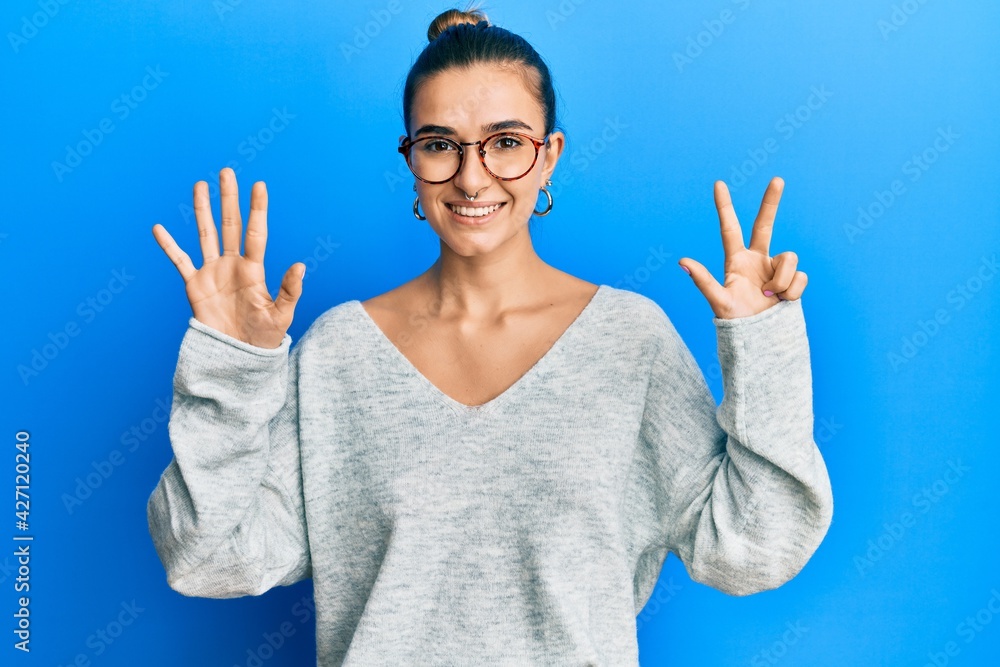 Young hispanic woman wearing casual clothes showing and pointing up with fingers number eight while smiling confident and happy.