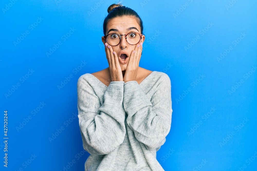 Young hispanic woman wearing casual clothes afraid and shocked, surprise and amazed expression with hands on face Young hispanic woman wearing casual clothes afraid and shocked, surprise and amazed expression with hands on face