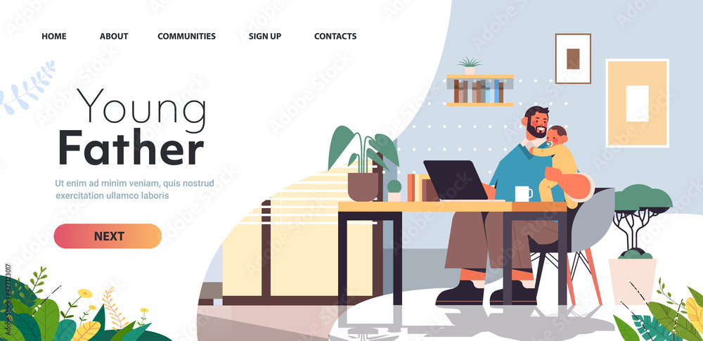 young father sitting at workplace with little son fatherhood parenting concept dad spending time with baby young father sitting at workplace with little son fatherhood parenting concept dad spending time with baby