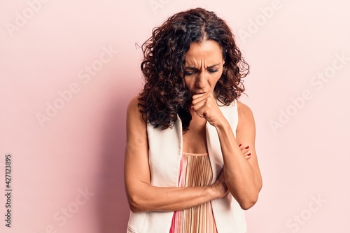 Middle age beautiful woman wearing casual vest feeling unwell and coughing as symptom for cold or bronchitis. health care concept.