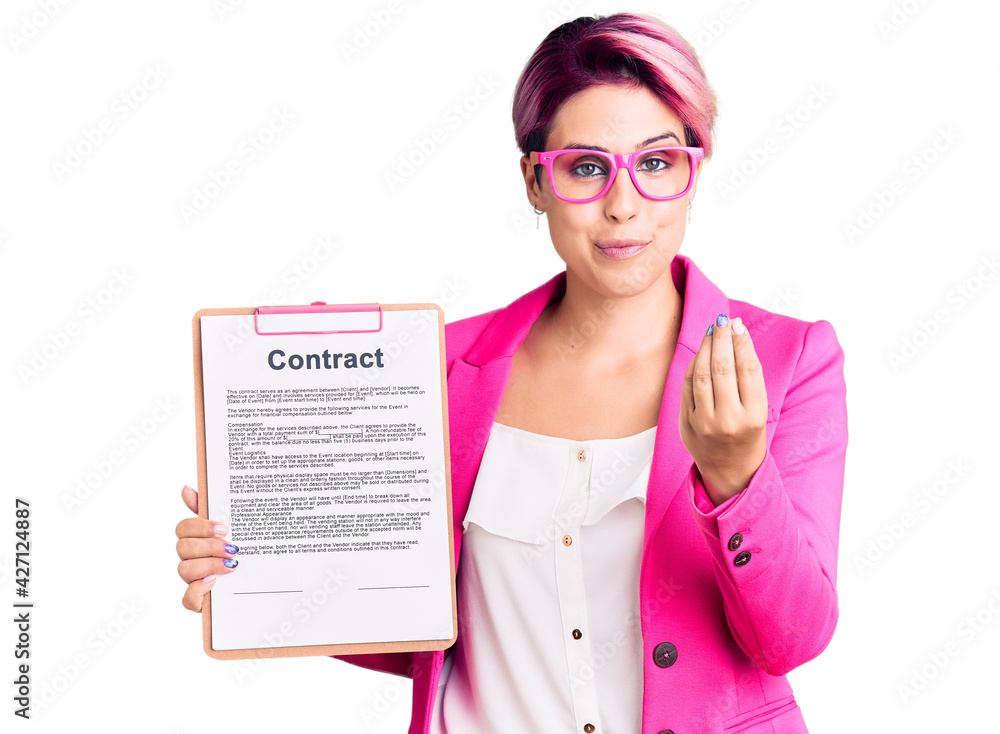 Young beautiful woman with pink hair holding clipboard with contract document doing money gesture with hands, asking for salary payment, millionaire business Young beautiful woman with pink hair holding clipboard with contract document doing money gesture with hands, asking for salary payment, millionaire business