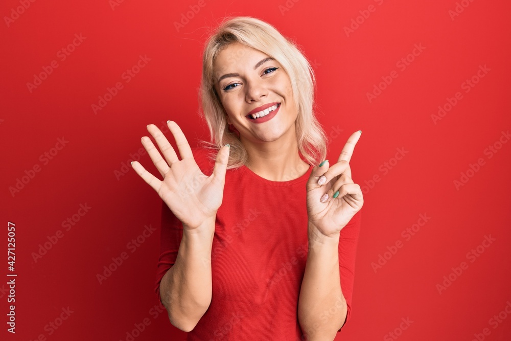 Young blonde girl wearing casual clothes showing and pointing up with fingers number six while smiling confident and happy. Young blonde girl wearing casual clothes showing and pointing up with fingers number six while smiling confident and happy.