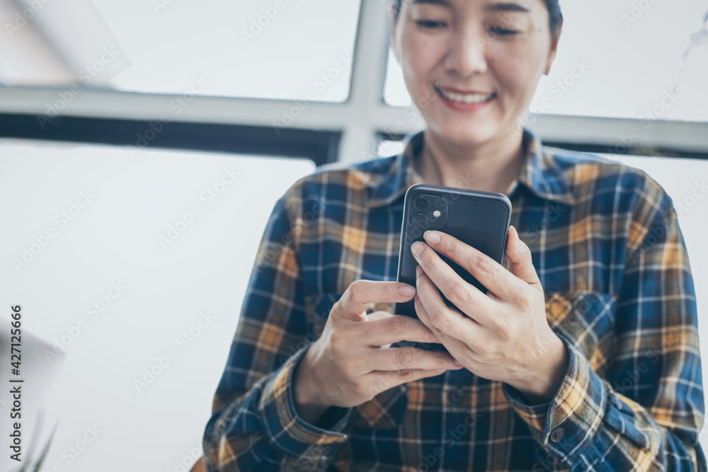 using cell phone hand holding mobile texting message contact us.chatting,search internet information in office.technology device communication connecting