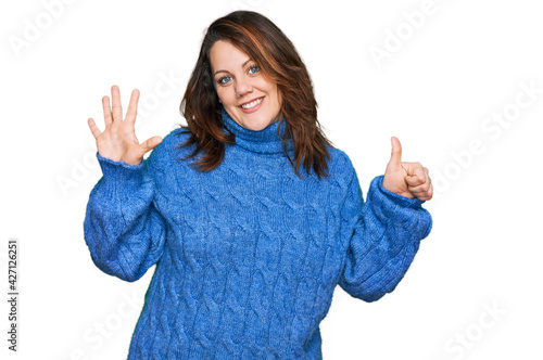 Young plus size woman wearing casual clothes showing and pointing up with fingers number six while smiling confident and happy.