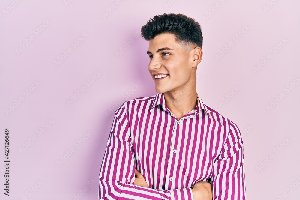 Young hispanic man wearing casual clothes looking to the side with arms crossed convinced and confident Young hispanic man wearing casual clothes looking to the side with arms crossed convinced and confident