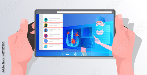 hans using tablet with doctor in mask examining x-ray viral pneumonia symptom coronavirus cells on screen