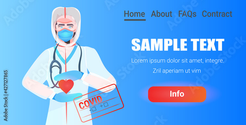 doctor in mask and protective suit holding red heart fight against covid-19 concept portrait