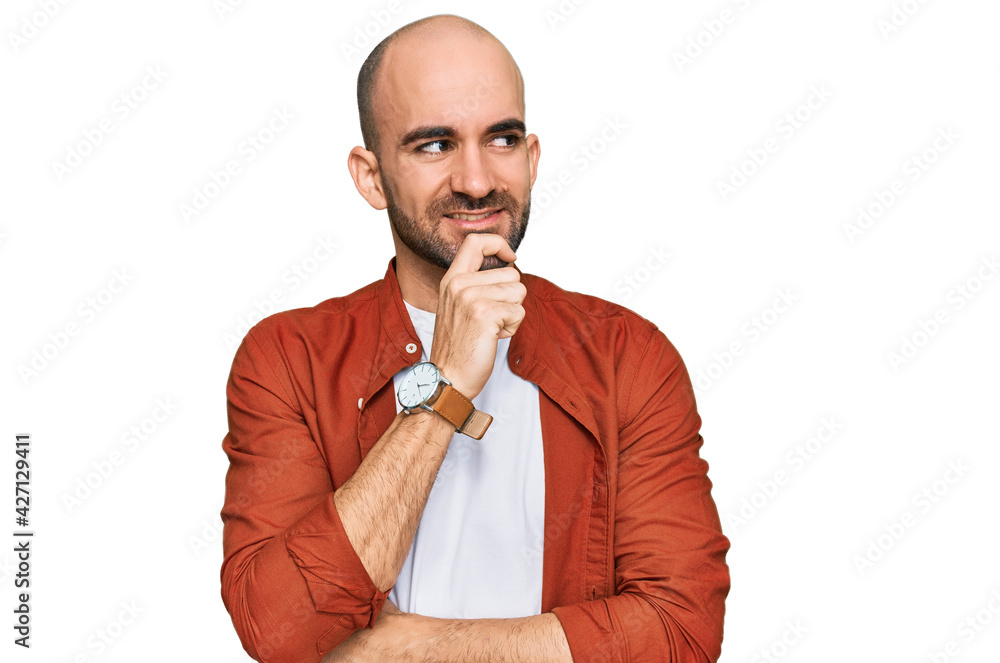 Young hispanic man wearing casual clothes with hand on chin thinking about question, pensive expression. smiling with thoughtful face. doubt concept. Young hispanic man wearing casual clothes with hand on chin thinking about question, pensive expression. smiling with thoughtful face. doubt concept.