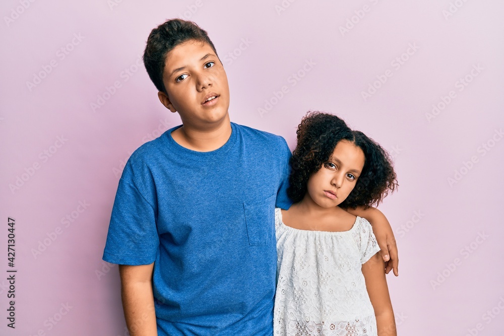 Young hispanic family of brother and sister wearing casual clothes together looking sleepy and tired, exhausted for fatigue and hangover, lazy eyes in the morning. Young hispanic family of brother and sister wearing casual clothes together looking sleepy and tired, exhausted for fatigue and hangover, lazy eyes in the morning.