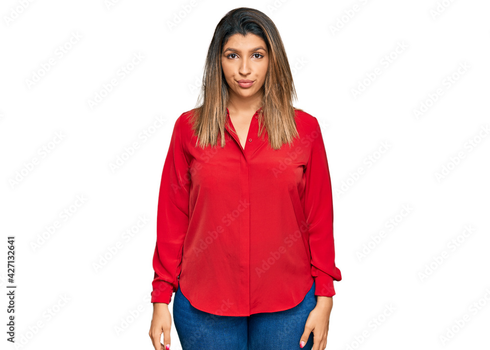 Beautiful brunette woman wearing casual clothes with serious expression on face. simple and natural looking at the camera. Beautiful brunette woman wearing casual clothes with serious expression on face. simple and natural looking at the camera.