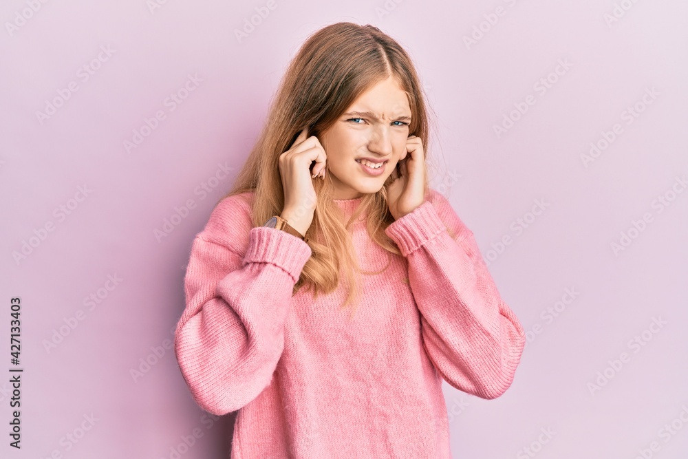 Beautiful young caucasian girl wearing casual clothes covering ears with fingers with annoyed expression for the noise of loud music. deaf concept. Beautiful young caucasian girl wearing casual clothes covering ears with fingers with annoyed expression for the noise of loud music. deaf concept.