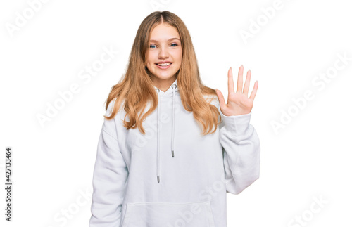 Beautiful young caucasian girl wearing casual sweatshirt showing and pointing up with fingers number five while smiling confident and happy.