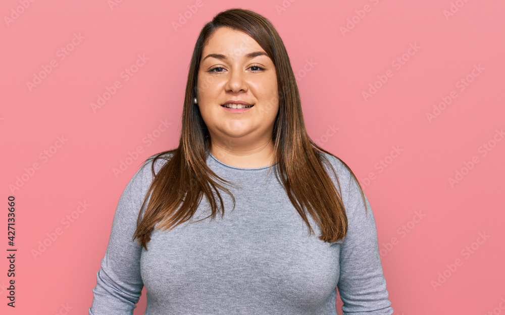 Fototapeta premium Beautiful brunette plus size woman wearing casual clothes with a happy and cool smile on face. lucky person.