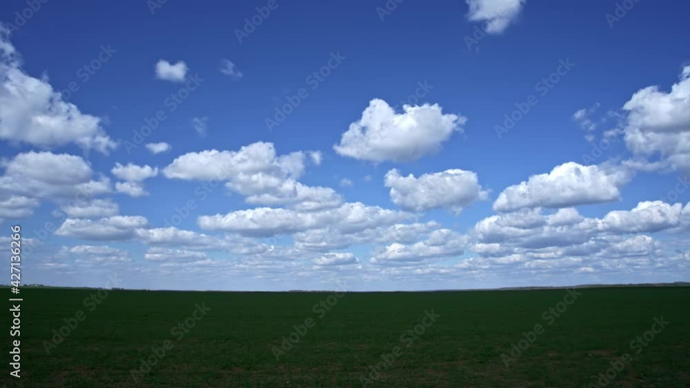 Green grassland scenery against blue sky and white clouds, time-lapse Green grassland scenery against blue sky and white clouds, time-lapse