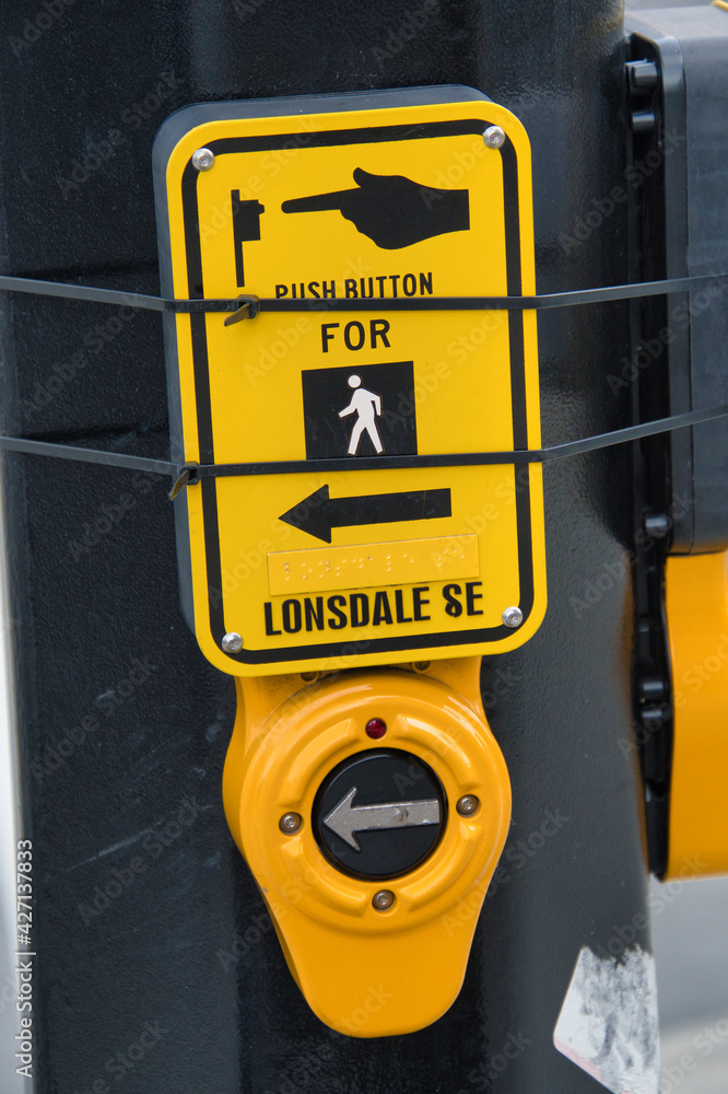 Fototapeta premium Push button to turn on the pedestrian traffic light. North Vancouver BC Canada 