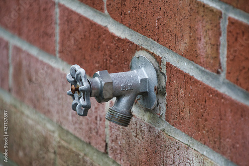 Exterior water tap attached to the wall.  North Vancouver BC Canada　

