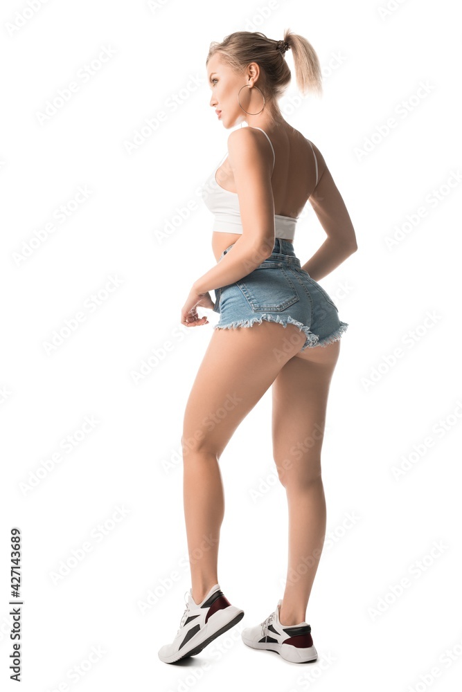 Cheerful young woman in sneakers stand back Cheerful young woman in sneakers stand back
