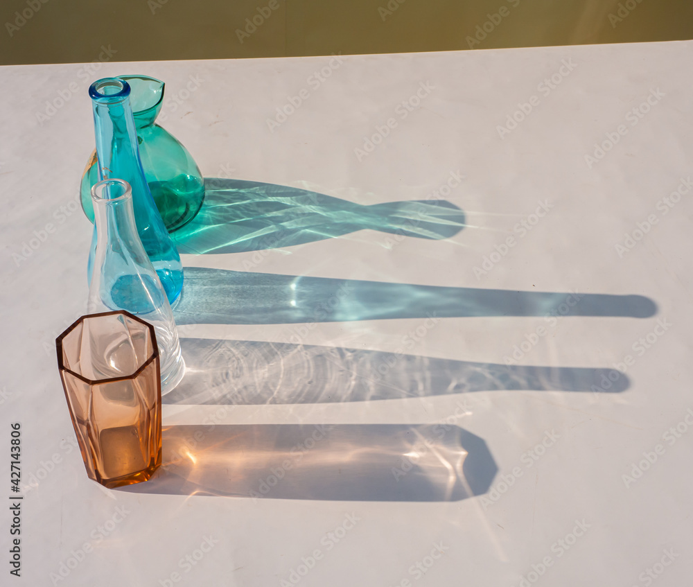 color on glass bottel in sunlight. reflection of colorful glass on ...