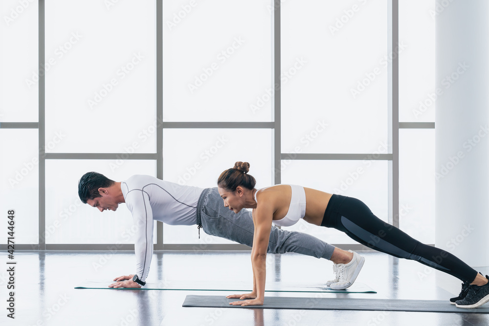 athletic couple workout  with push up in gym and fitness center
