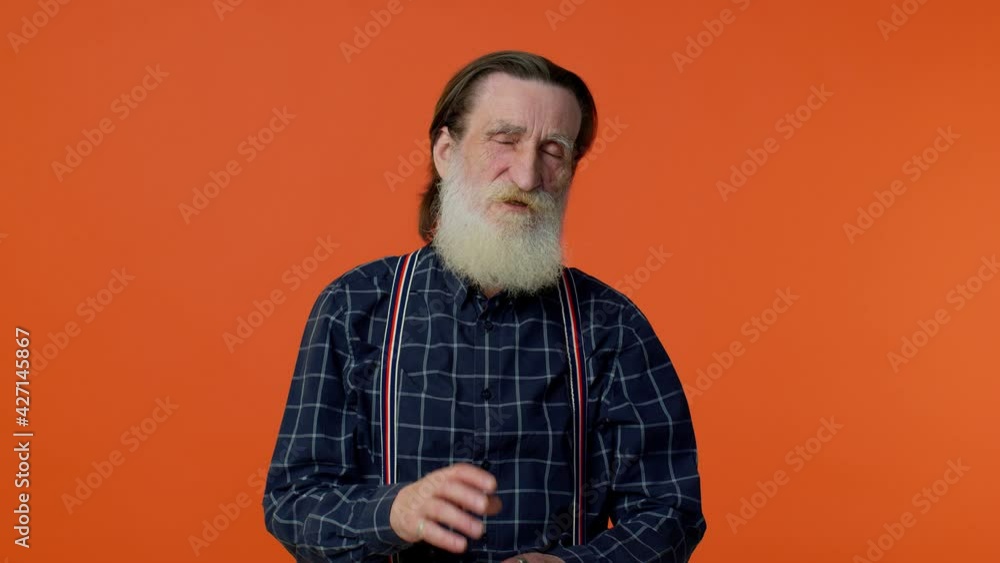 Elderly bearded gray-haired man yawning, sleepy inattentive feeling somnolent lazy bored gaping suffering from lack of sleep. Senior old grandfather isolated on orange background. People emotions Elderly bearded gray-haired man yawning, sleepy inattentive feeling somnolent lazy bored gaping suffering from lack of sleep. Senior old grandfather isolated on orange background. People emotions