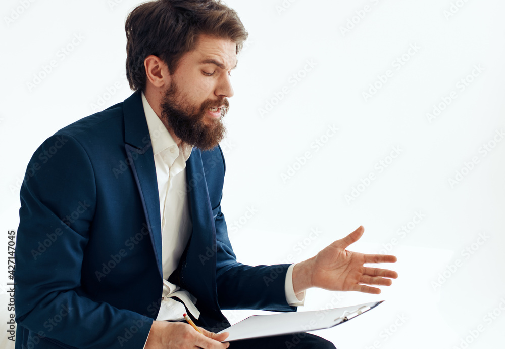 businessman in suit with documents on knees on light background cropped view businessman in suit with documents on knees on light background cropped view