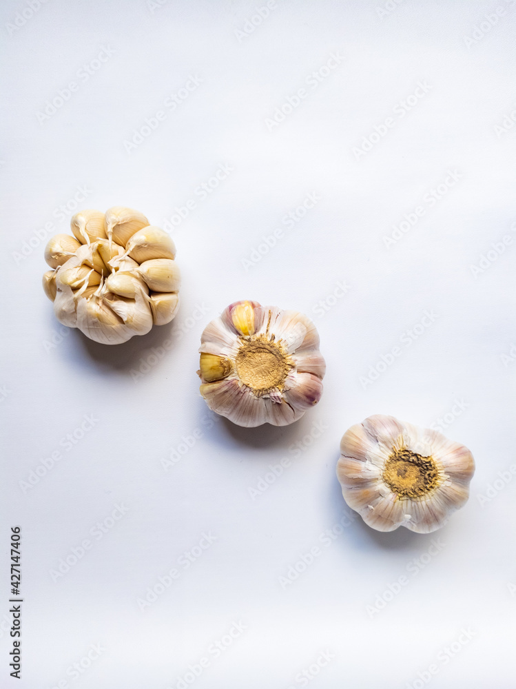 three fresh and raw garlic isolated on white background.