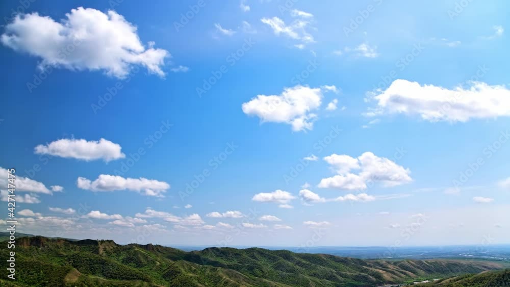 Mountain in spring and white clouds in blue sky, time-lapse Mountain in spring and white clouds in blue sky, time-lapse