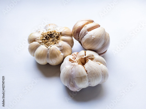 three fresh and raw garlic isolated on white background.