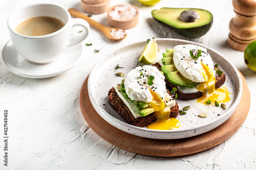 Sandwich with avocado and poached egg. Healthy nutritious paleo keto breakfast concept Sandwich with avocado and poached egg. Healthy nutritious paleo keto breakfast concept