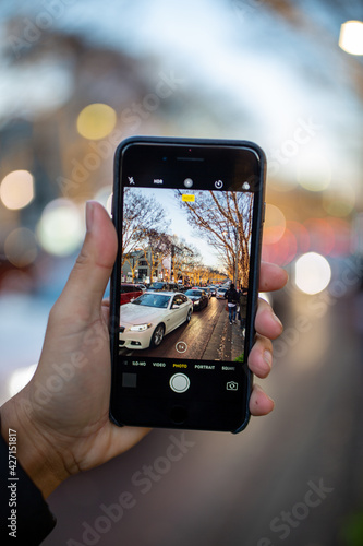 Close Up Of A Hand Taking Photo Of Cars in City