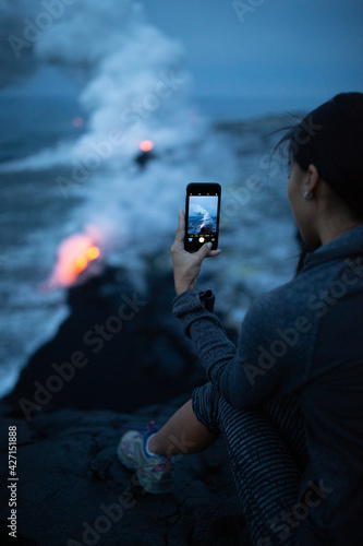 Hawaii lava tourist. Tourists taking photo of flowing lava from Kilauea volcano around Hawaii volcanoes national park, USA.