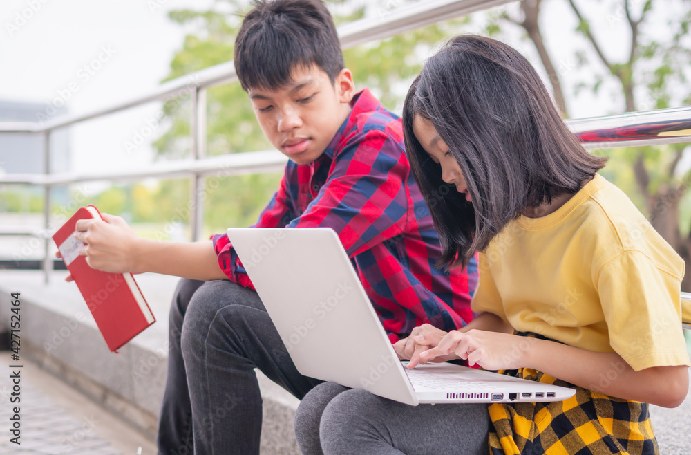 Asian kid girl with boy sitting and learning with laptop, education concepts Asian kid girl with boy sitting and learning with laptop, education concepts