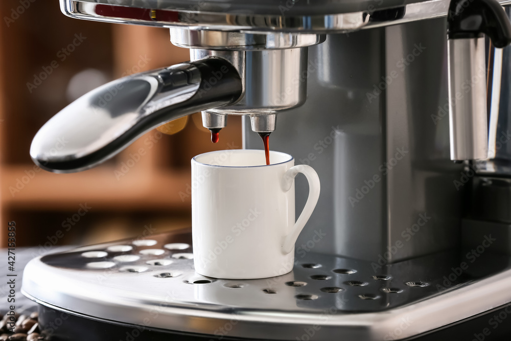 Modern coffee machine with cup of hot espresso in cafe Modern coffee machine with cup of hot espresso in cafe