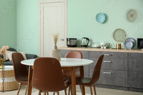 Dining table and chairs in interior of modern kitchen © Pixel-Shot
