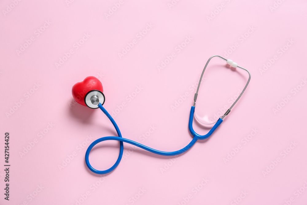 Modern stethoscope and heart on color background Modern stethoscope and heart on color background