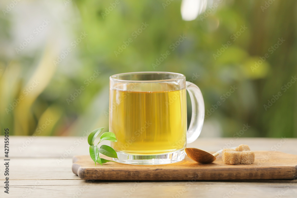 Cup of green tea on table outdoors Cup of green tea on table outdoors