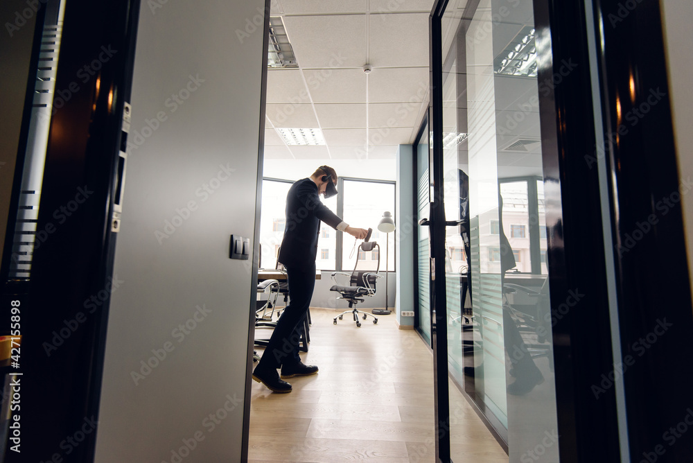 A man in 3D glasses in a business suit in the office. A man in 3D glasses in a business suit in the office.