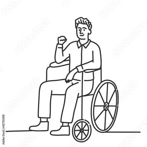 Happy man in wheelchair with raised fist.