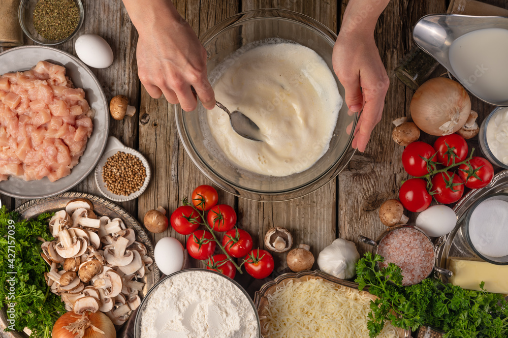 Fototapeta premium Cooking pizza, the chef makes a pie. Dough preparation, step-by-step process, with ingredients in the background.