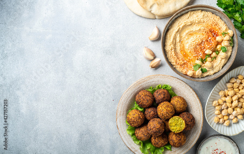 Obraz na plátně Chickpea dishes, falafel and hummus, on a concrete background, top view, copy sp