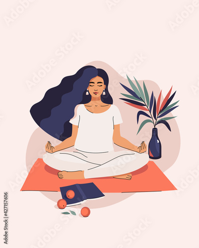 Vector beautiful brunette woman doing yoga in lotus position on the mat next to plants, book and tangerines at home