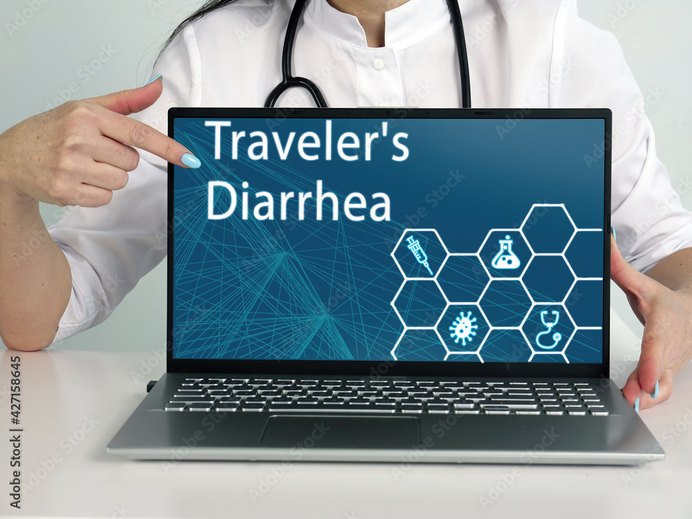 Traveler's Diarrhea text in menu. Hematologist looking for something at laptop Traveler's Diarrhea text in menu. Hematologist looking for something at laptop