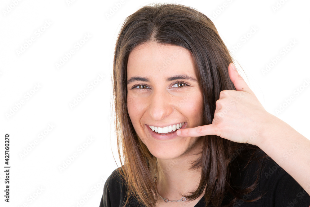 happy beautiful woman in white background smiling making phone gesture with hand and fingers like talking on cellphone happy beautiful woman in white background smiling making phone gesture with hand and fingers like talking on cellphone