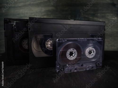 Audio cassette and video cassette. Old, vintage cassette on a black background. Retro.