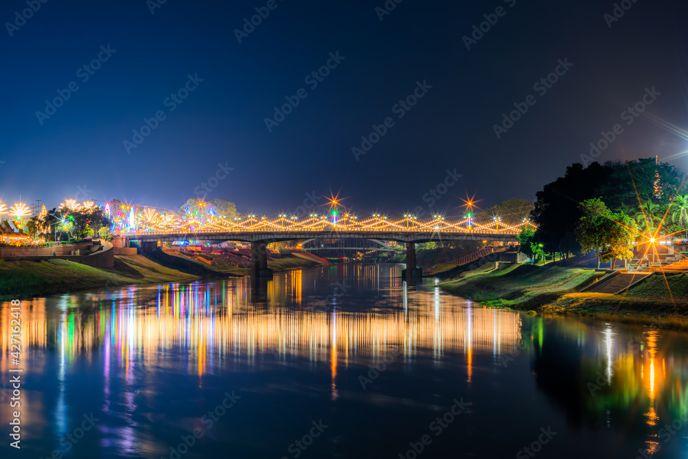 Beautiful light on the Nan River at night on the bridge (Naresuan Bridge) on the Road in Realm for Naresuan the Great Festival and Annual event in Phitsanulok,Thailand.